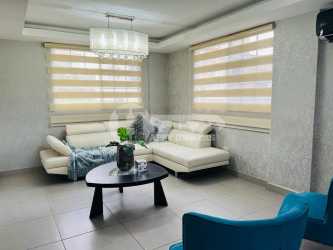 Living space with staircase turquoise chairs and decor Villas del Golf Chitre Panama