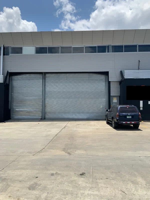 Industrial warehouse loading dock with ramp and metal shutters at Las Mañanitas Panama