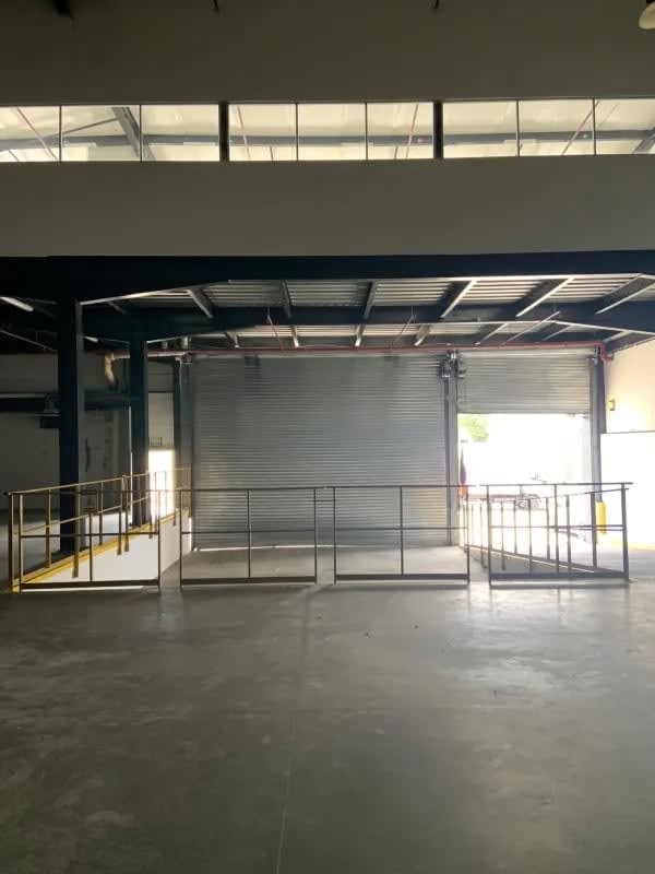 Empty warehouse with concrete floors, high ceilings and industrial lighting Panama City