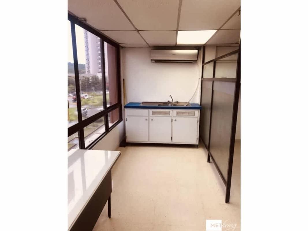 Bright kitchenette with blue counter cabinets window Torre Empresarial El Dorado Panama