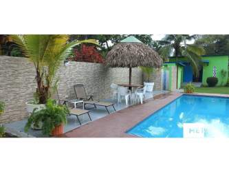 Single-story beach home with covered patio and lush garden in Gorgona San Carlos Panama