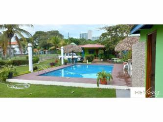 Private swimming pool with palapa umbrellas, gardens Gorgona San Carlos Panama beach house