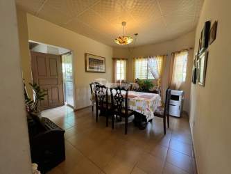 Living room area with tile flooring, large windows and neutral colors in Urb Bolívar Márquez home for sale