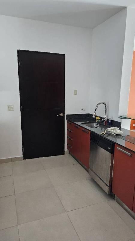 Granite countertop open kitchen with appliances and dining area overlooking ocean in PH Destiny Tower Panama