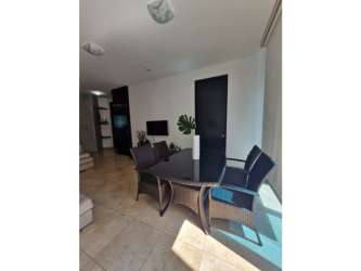 Open-plan living and dining room with tile floors and terrace access at Playa Blanca Resort Panama