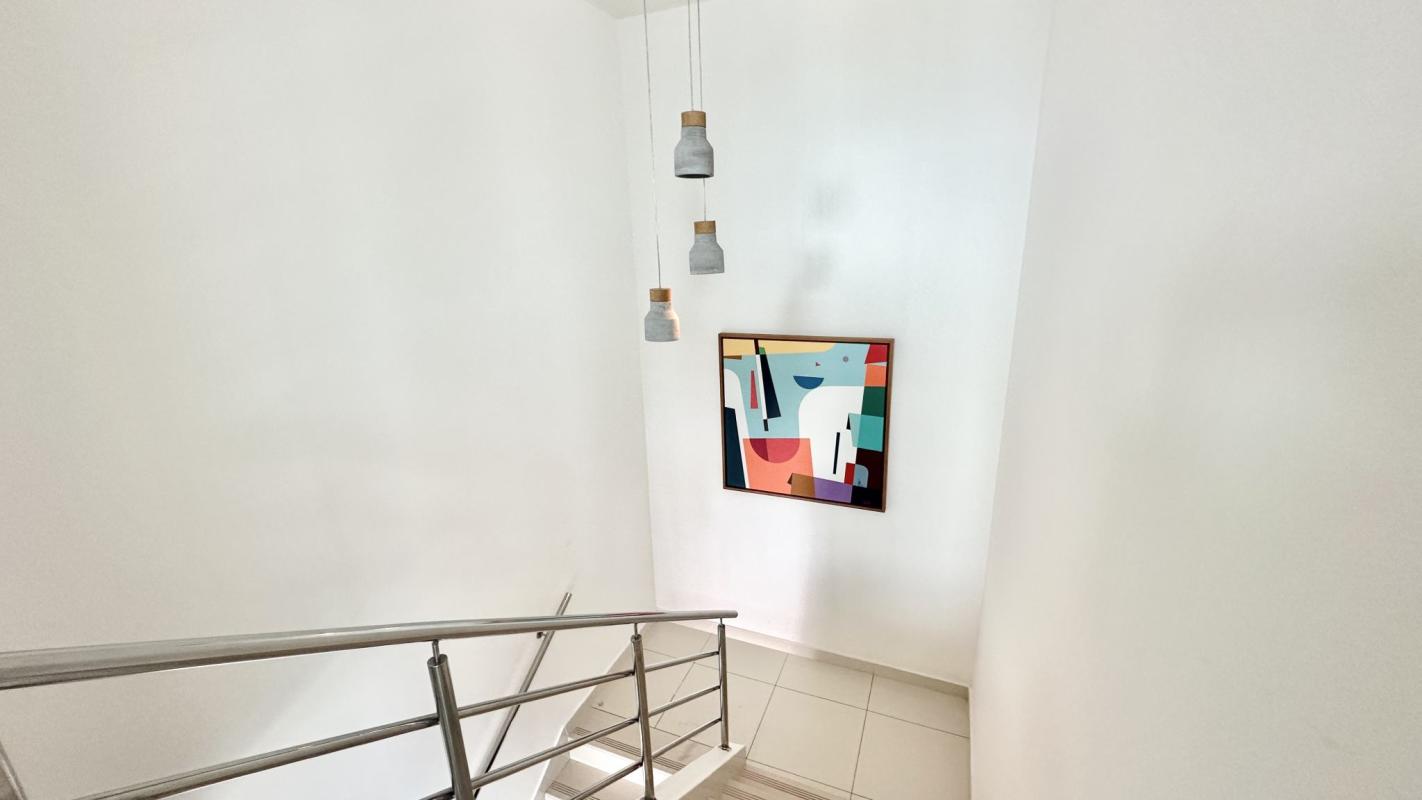 Open living area with floor-to-ceiling windows, balcony access, city views in PH Park Loft Panama City