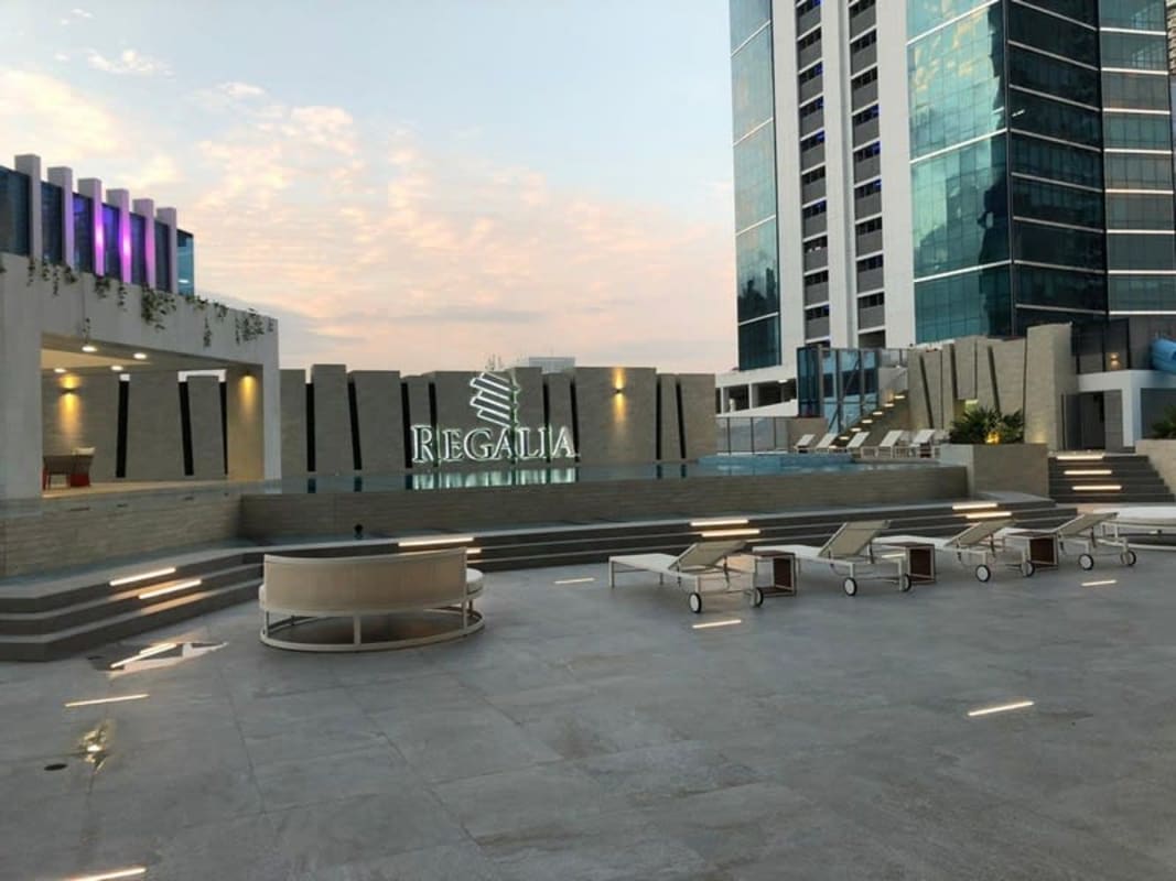 Luxury pool with city views at PH Regalia Costa del Este Panama with lounge chairs and water slide