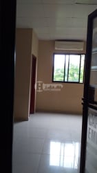 Interior of office with air conditioning unit, large window, tiled floor for rent in Chitré