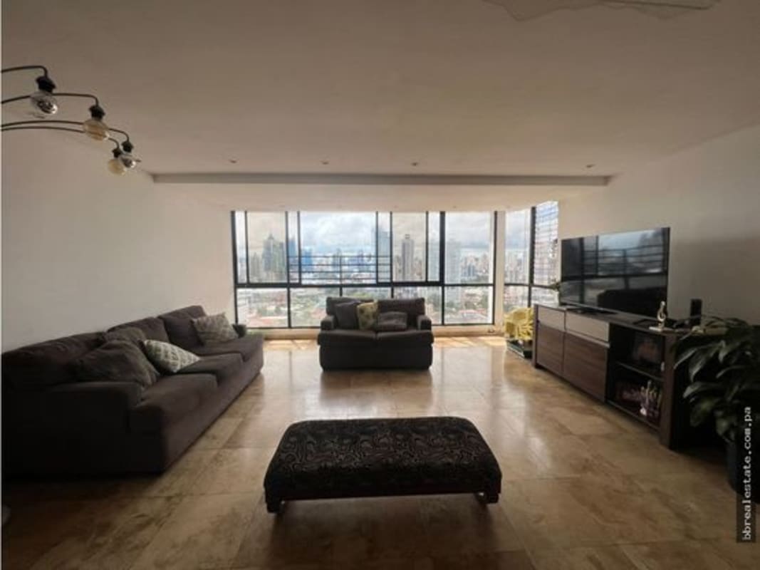 Modern kitchen with red cabinets and spiral staircase in penthouse at PH Country Park Coco del Mar Panama