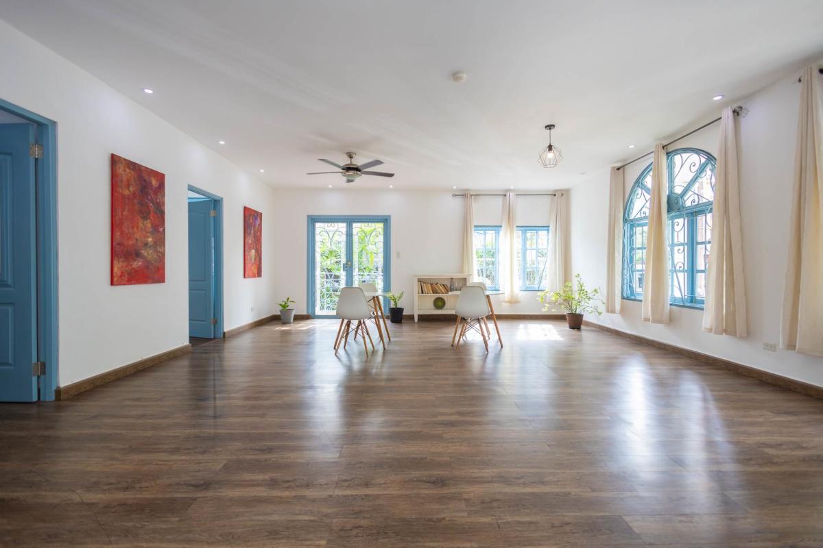 Coastal inspired kitchen with blue cabinetry and large window Obarrio Panama