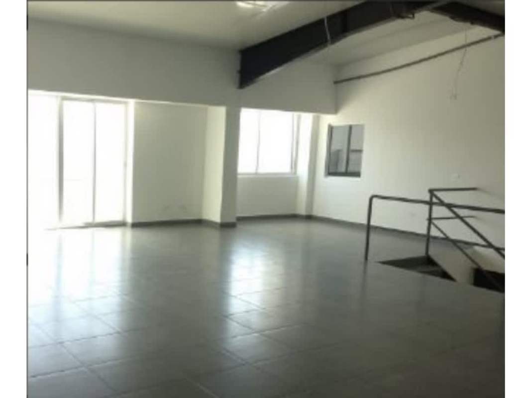 Loft style office area with sliding glass door large windows inside commercial warehouse Vía Tocumen Panama