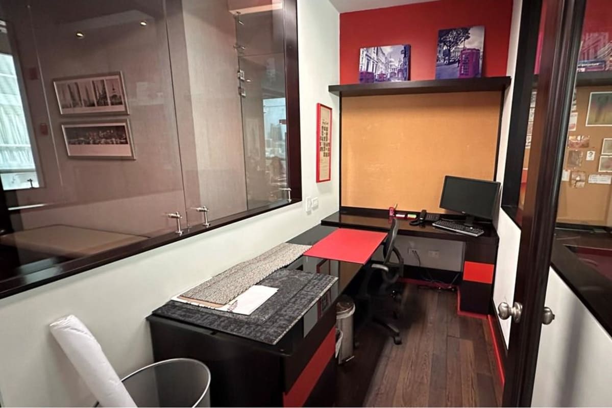 Modern private office with glass partitions, cork wall, and stylish desk in Blue Business Center Panama City