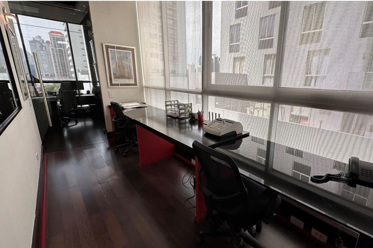 Bright private office with panoramic city views, glass wall, wood flooring at PH Blue Business Center Panama City