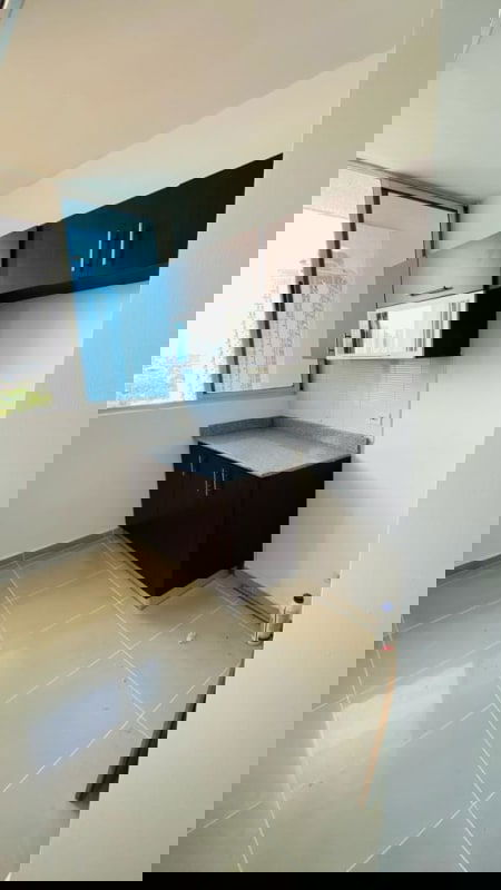 Renovated kitchen with granite counters and large window in Vision Tower apartment Panama City