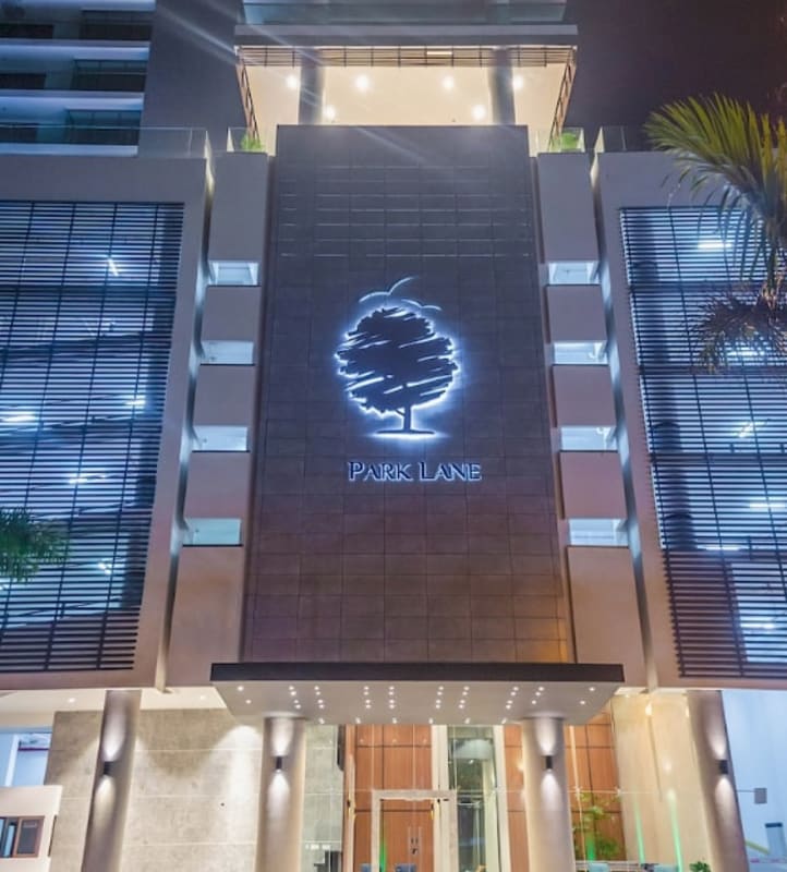 Grand modern lobby with mirrored columns, wood panel walls, pendant lights at PH Park Lane Costa del Este Panama