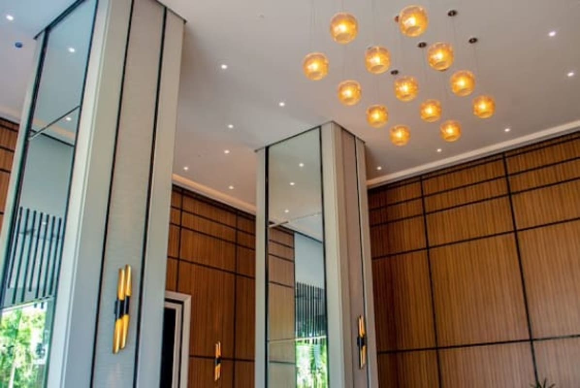 Modern open plan living dining with windows, chandeliers, marble floors in PH Park Lane Costa del Este Panama