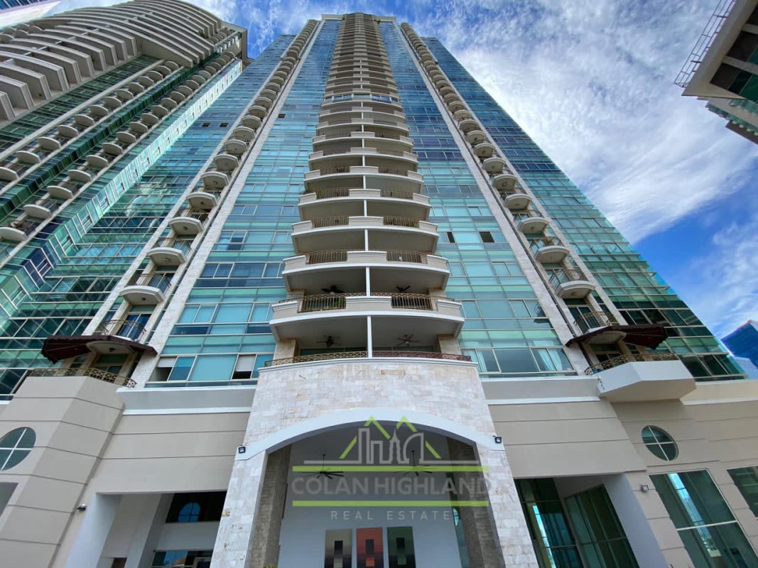 Spacious modern kitchen with island, marble countertops, appliances and city skyline view Pacific Point Penthouse Panama