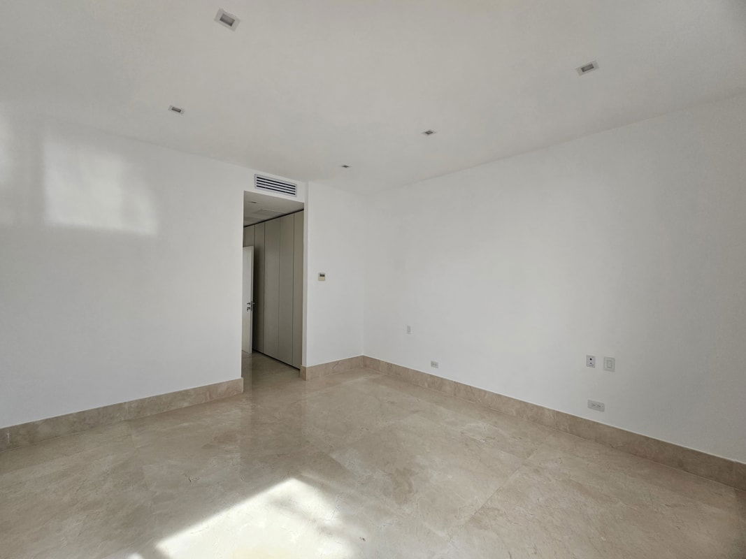 Spacious bright living room with floor-to-ceiling windows and marble floors in PH Garden Apartments Ocean Reef