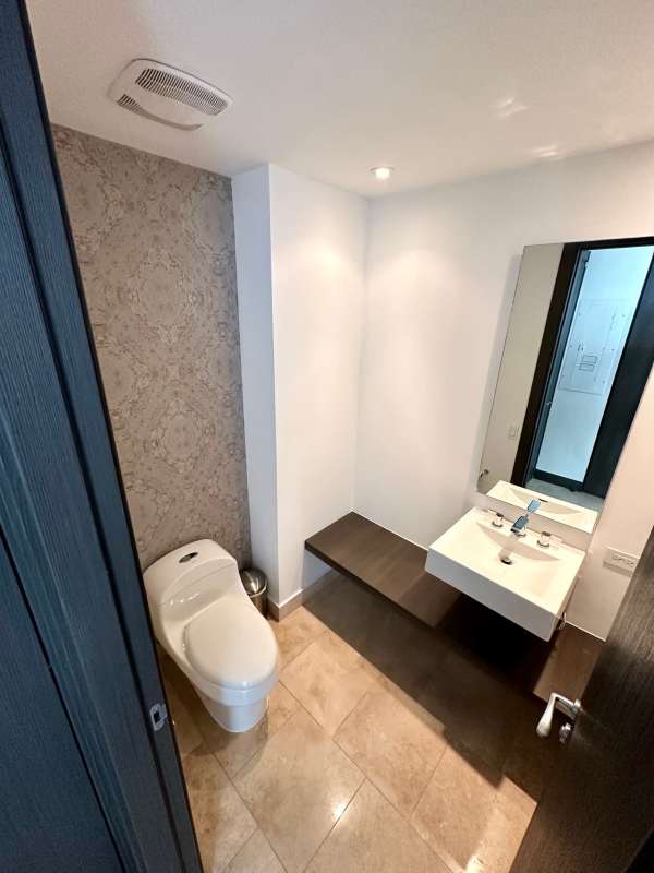Bright living room with floor-to-ceiling windows and Pacific ocean view in Trump Ocean Club Panama