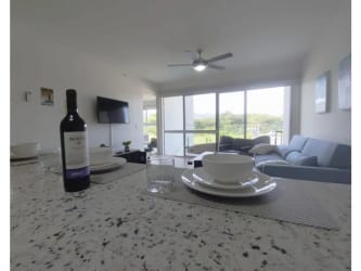 Open concept living room dining area with balcony and ocean views Playa Caracol Panama