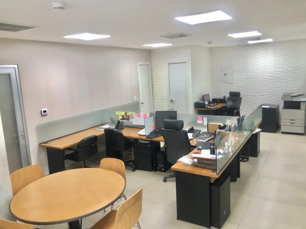 Modern open office layout with glass partitions, workstations and meeting table in Punta Paitilla Panama