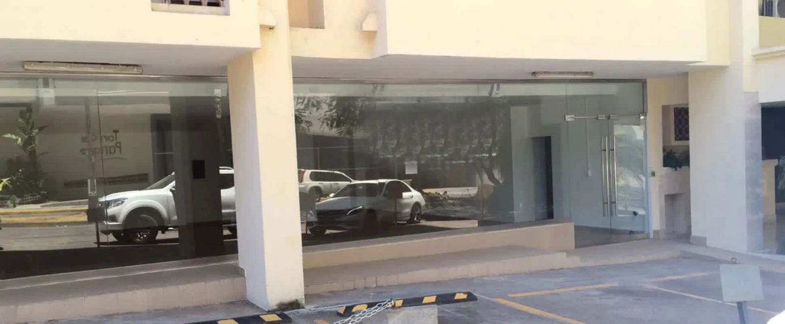 Glass storefront entrance with parking at Punta Paitilla commercial space Panama City