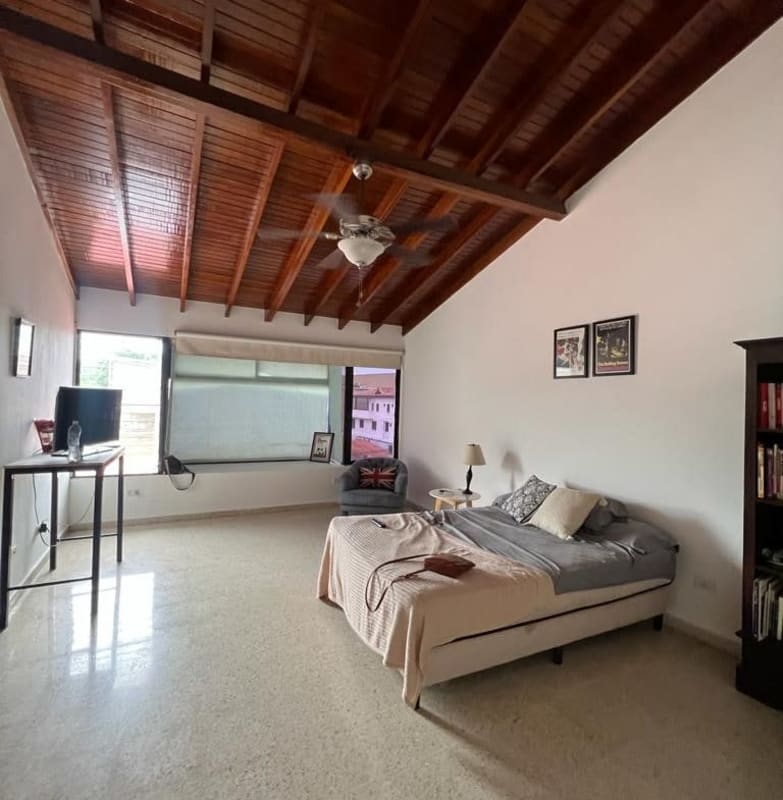 Spacious bedroom wood ceiling large window natural light Villa de las Fuentes
