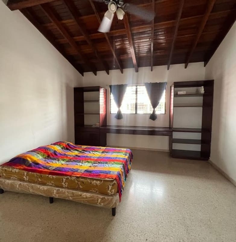 Bedroom with wood beams, large window, shelves Villa de las Fuentes Bethania