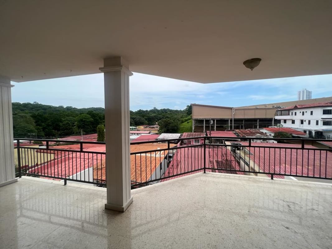 Balcony with metal railing overlooking city and Metropolitan Park Panama