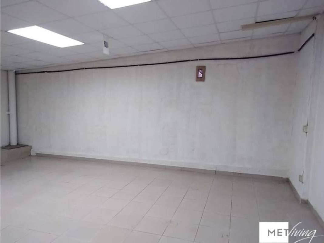 Street view of red commercial facade with metal shutters in Parque Lefevre Panama City