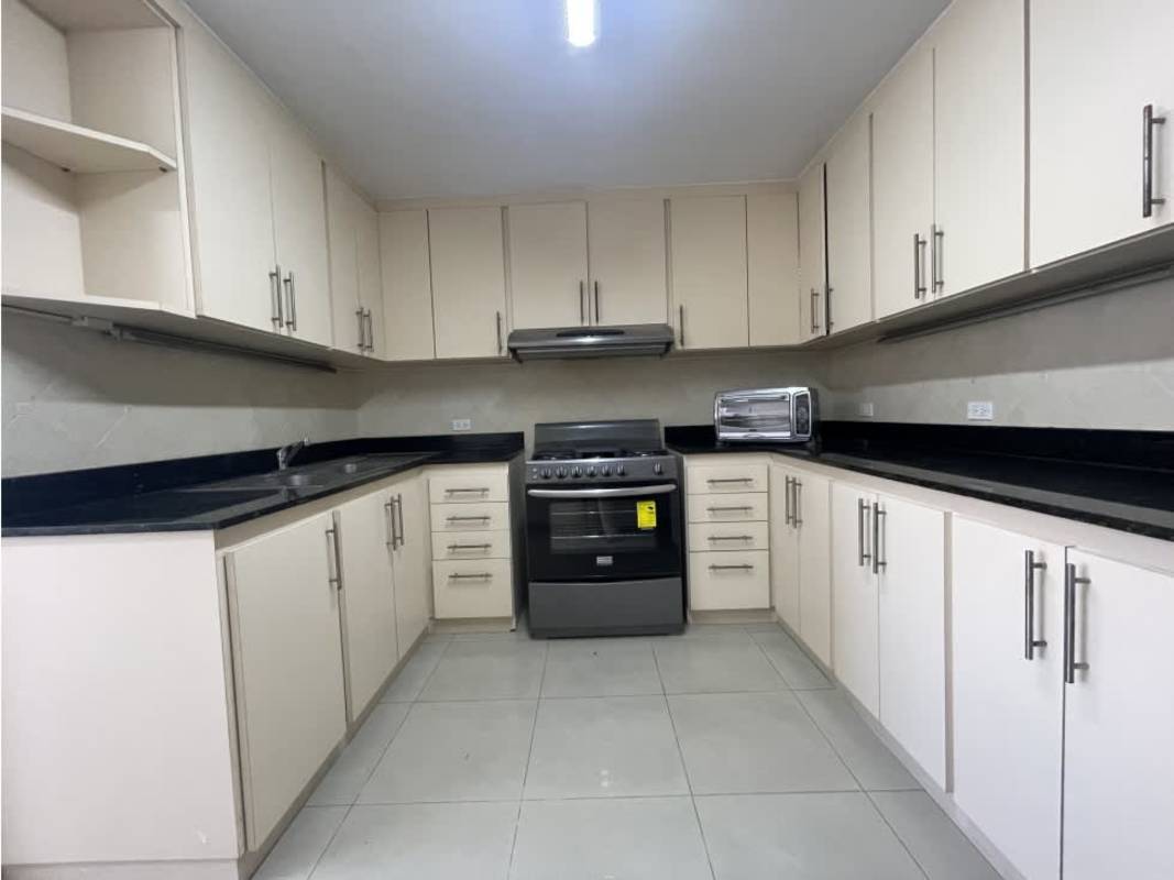 Spacious kitchen with cream cabinets granite countertops and appliances in PH Monaco Obarrio Panama
