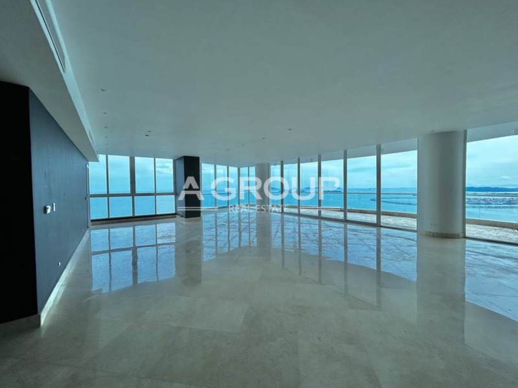 Luxury apartment spacious living room with ocean views marble floors floor-to-ceiling windows