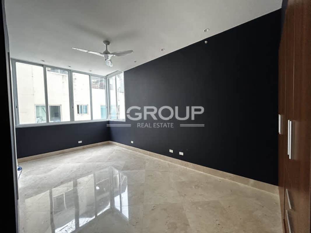 Modern gym ocean view floor-to-ceiling windows treadmills machines The Point Paitilla Panama