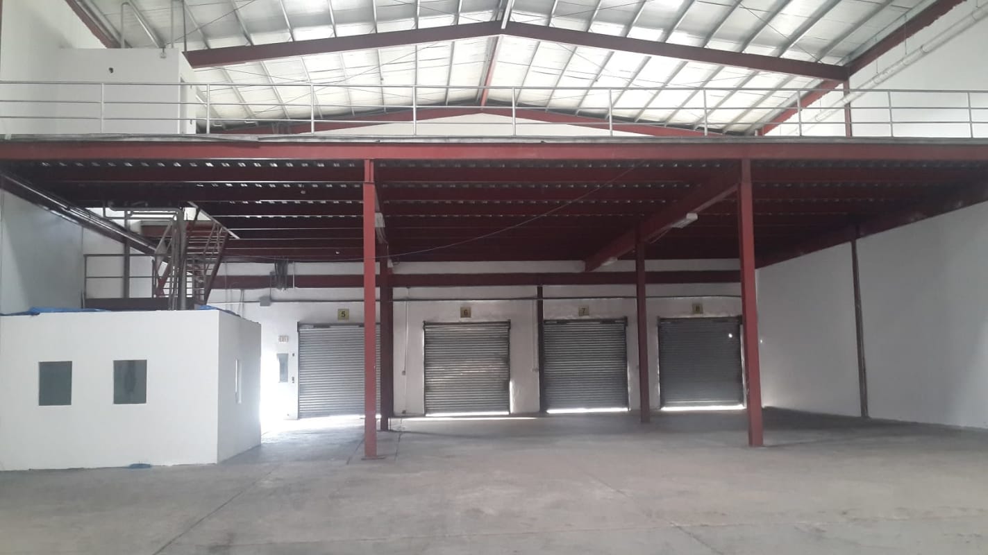 Empty warehouse interior with four loading bays, mezzanine and security in industrial park Panama