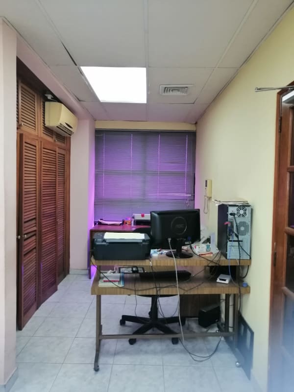 Traditional office workspace with desks, computers, partitioned walls in Obarrio Panama City