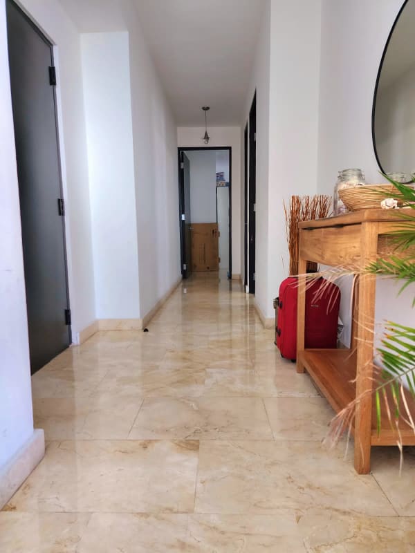 PH Alcalá modern tower facade with glass balconies and palm trees Costa del Este Panama