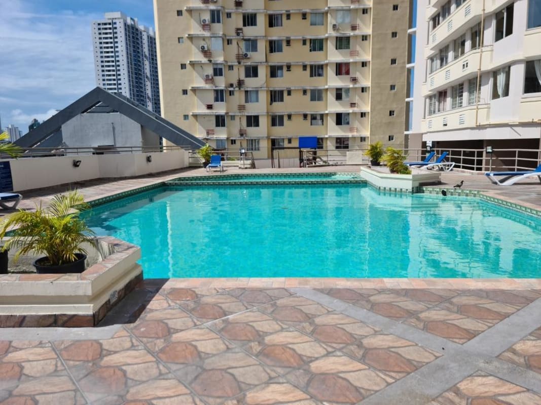 Rooftop swimming pool with lounge chairs city backdrop PH Brisas de San Fernando Panama