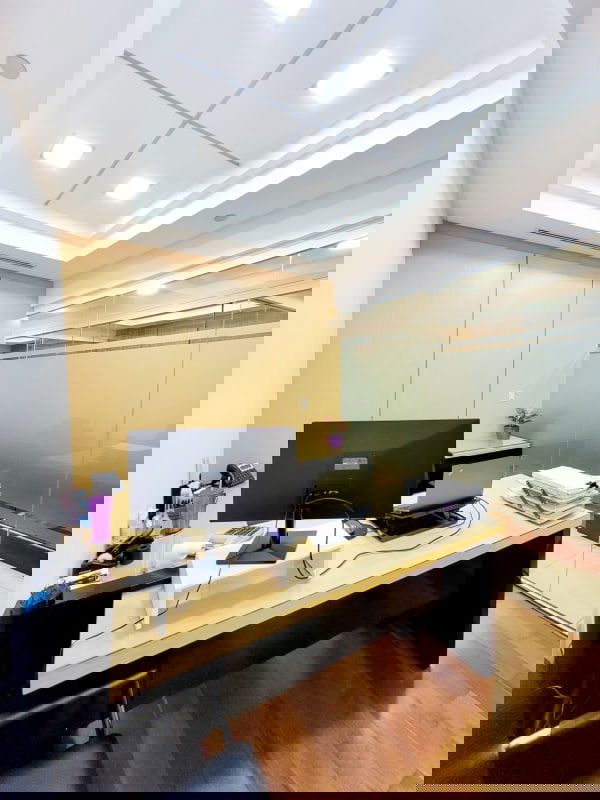 Meeting space with glass wall, wood paneling and recessed lighting in PH BICSA Financial Center