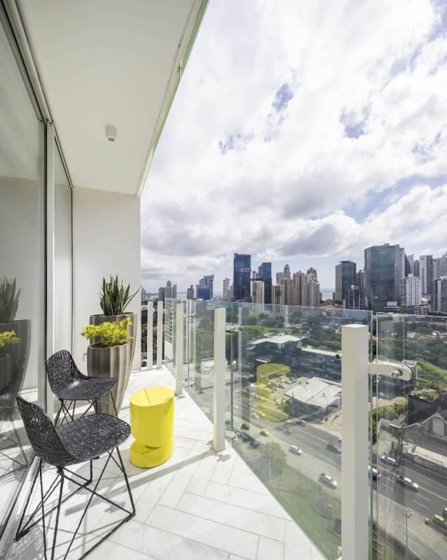Elegant bathroom with marble counters and glass shower in Wanders & Yoo Panama apartment