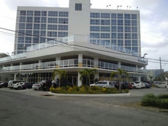 Bright bedroom with large windows queen bed yellow bedding blinds in PH Ibiza Playa Coronado Panama