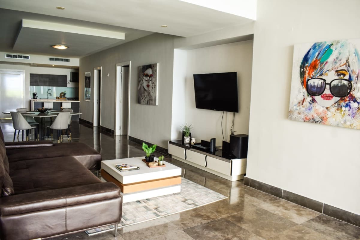 Spacious bedroom with ocean views, floor-to-ceiling windows and luxury furnishings at Yoo Panama