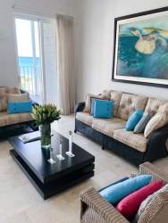 Living and dining area with floor-to-ceiling windows oceanfront views in Nueva Gorgona Panama
