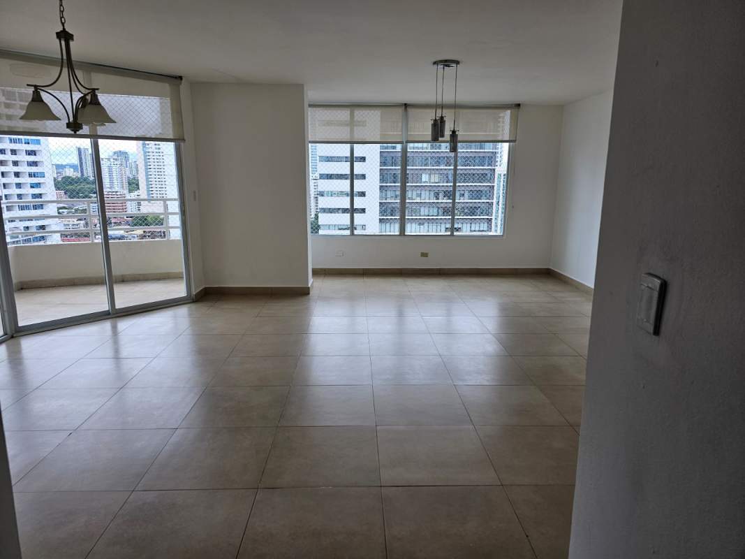 Open concept living and dining area with large windows, balcony access, and tile flooring in PH Serenity Via Porras Panama City