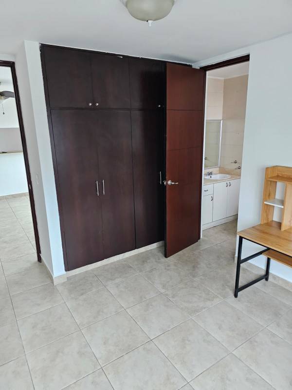 Modern bathroom with double sinks, glass shower, large mirror, beige tiling in PH Serenity Panama