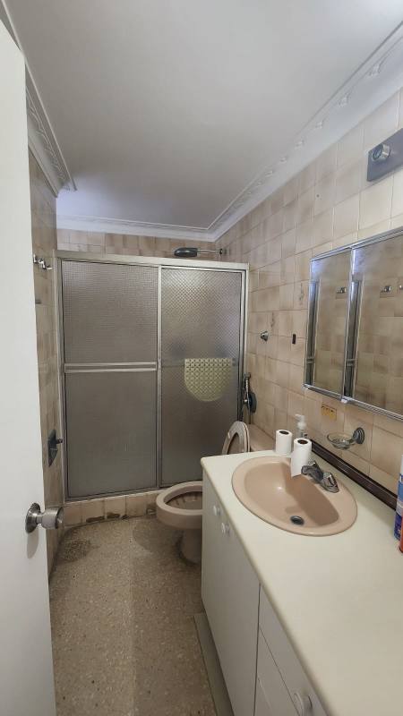 Laundry area with basin, racks, large window city view in Park City Panama