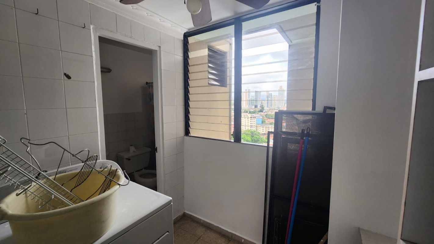 Bedroom with wide window, ceiling fan, urban skyline view Obarrio Panama City