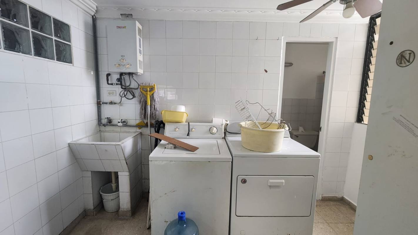 Laundry space with big window, city view, cleaning supplies in Obarrio Panama