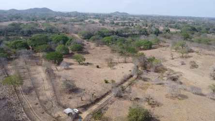 Country lot aerial view with open land, hills, access path in Panama