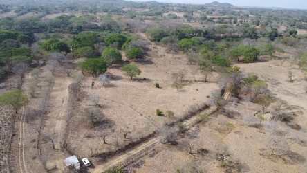 Vehicle visible near open countryside and river in Los Olivos Panana