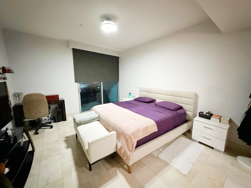 Secondary bedroom with city skyline view, large window, minimalist decor in Grand Tower Punta Pacifica Panama